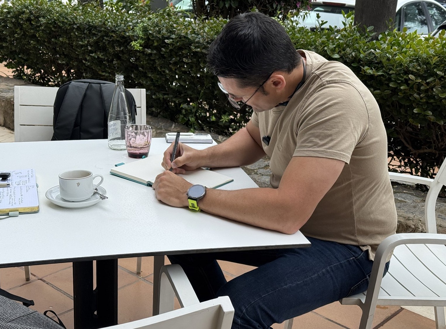 Manuel working through a case file at a café in Málaga